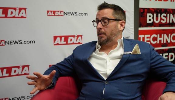 Drew Murray, Republican candidate for City Council At-Large, sitting in red chair 