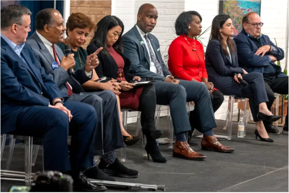 Eight mayoral candidates are on stage during a forum