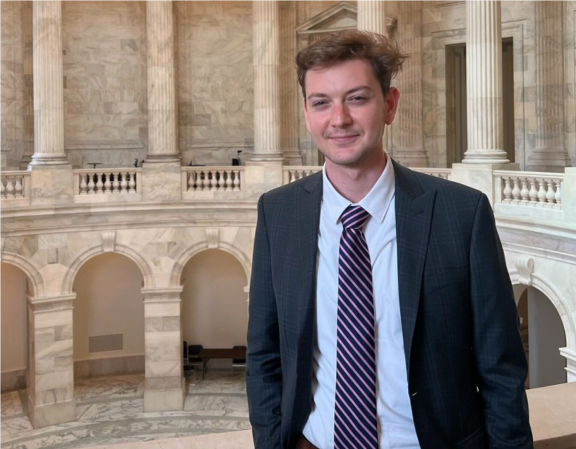 Harrison Morgan wearing a suit inside city hall