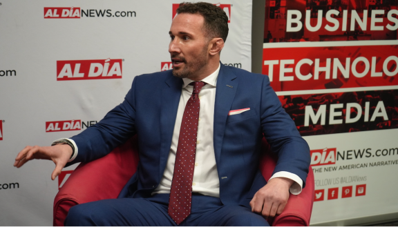 Sam Oropeza being interviewed in a red chair