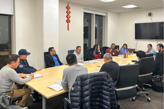 12 people sitting around a conference table