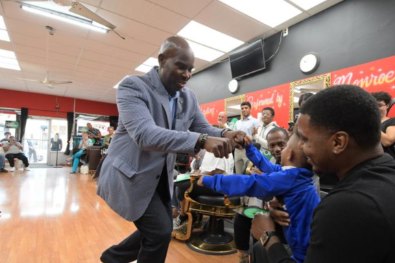 Derek Green fist bumping a young person