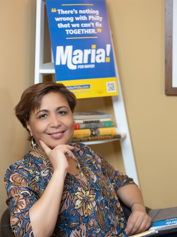 Maria Quiñones-Sánchez in front of her campaign sign