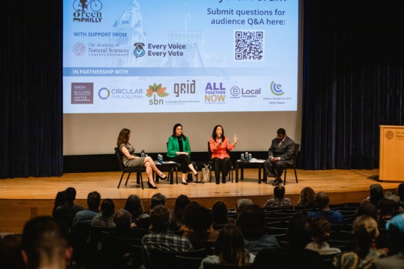 Three mayoral candidates and forum facilitator on stage for Green Philly's Climate Mayoral Forum