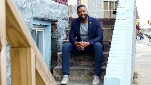 Amen Brown sitting on a front stoop