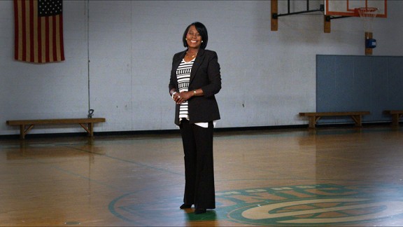 Cherelle Parker smiling at the camera and standing in a school gymnasium 