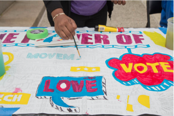 A hand panting on a community paint project 