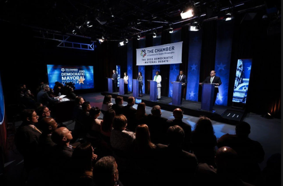 Mayoral candidates on stage at a forum hosted by the Chamber of Commerce