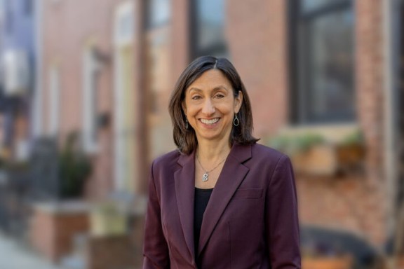 Rue Landau standing in front of brick townhomes