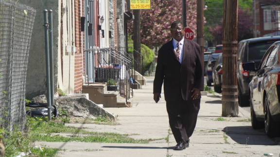 Warren Bloom walking down street