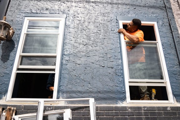 Contractor installing a window