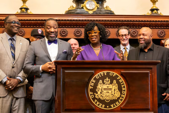 Mayor Cherelle L. Parker speaks during a news conference about a plan to redevelop Brith Sholom House in Wynnefield. From left to right is PHA President and CEO Kelvin Jeremiah, City Council President Kenyatta Johnson, Parker, and Ryan N. Boyer, business manager of the Philadelphia Building and Construction Trades Council. Tyger Williams / Staff Photographer