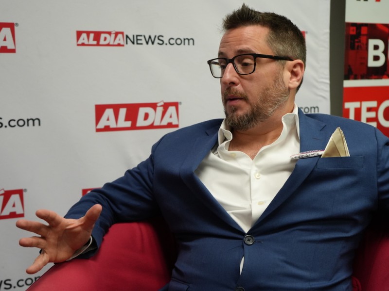 Drew Murray, Republican candidate for City Council At-Large, sitting in red chair 