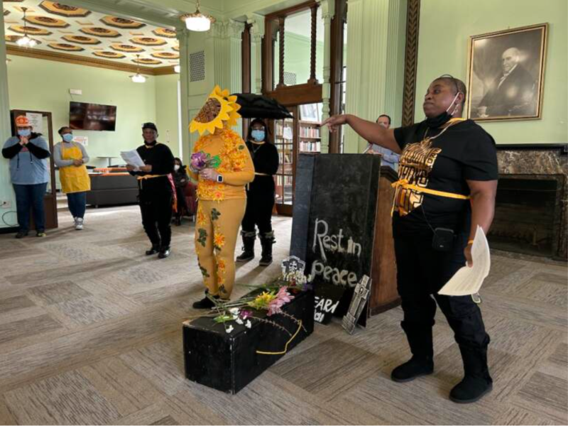 six members of an activist group performing a skit about illegal dumping