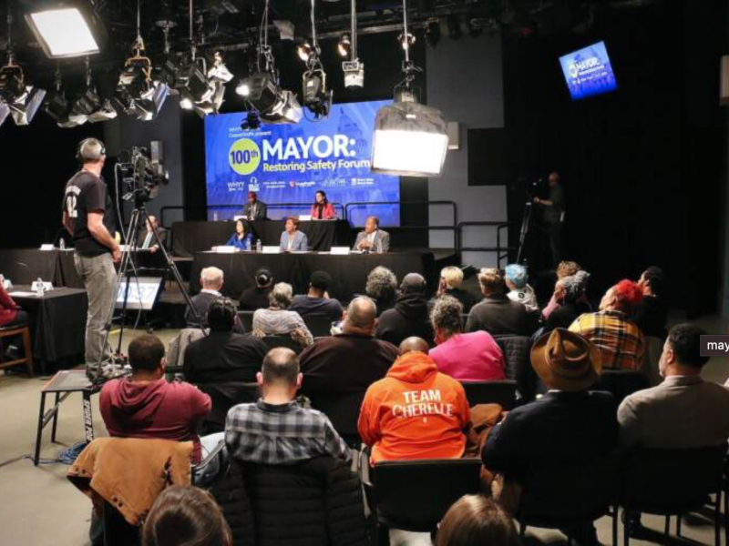 Mayoral candidates sitting on a stage in front of an audience in a TV studio