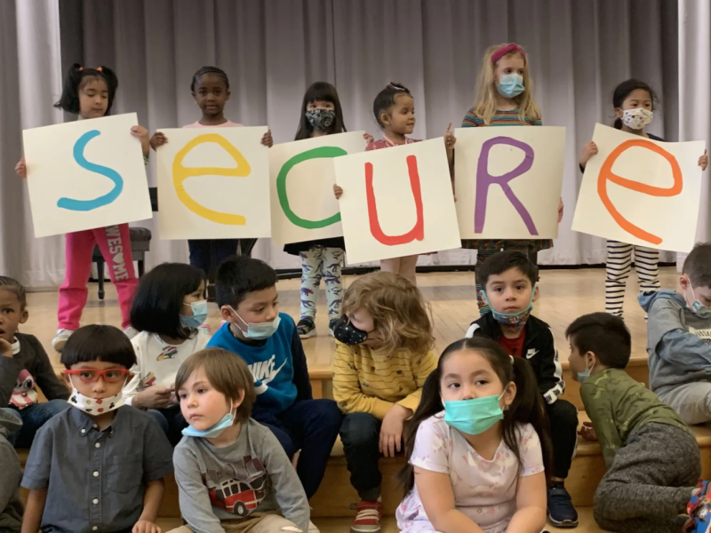 Children from the Kaleidoscope early childhood program in South Philadelphia hold up letters spelling out “Secure”