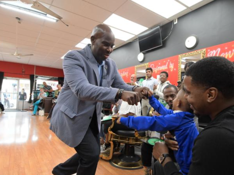 Derek Green fist bumping a young person