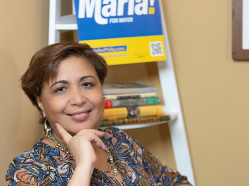 Maria Quiñones-Sánchez in front of her campaign sign