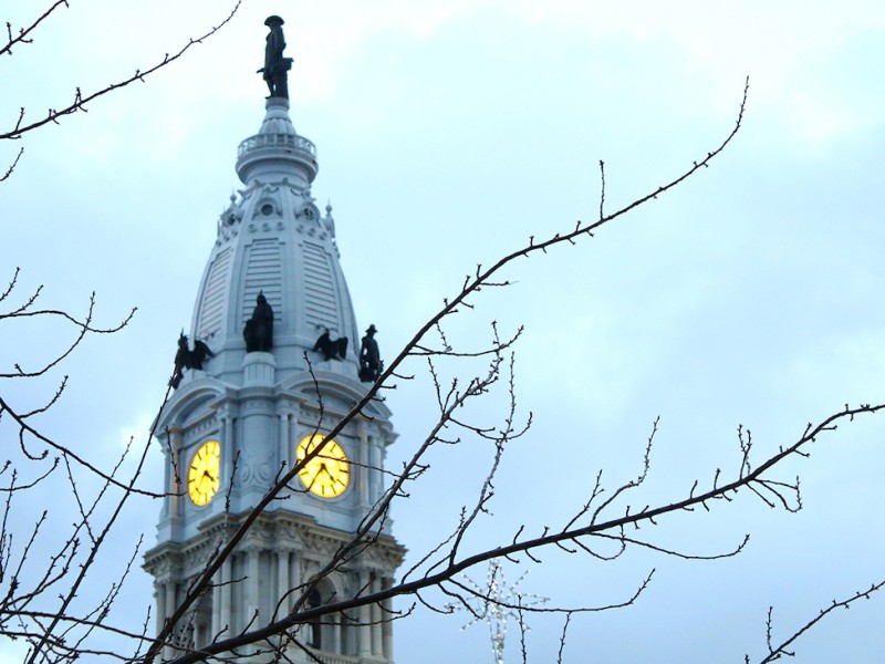 Philadelphia City Hall with bare tree branches in winter