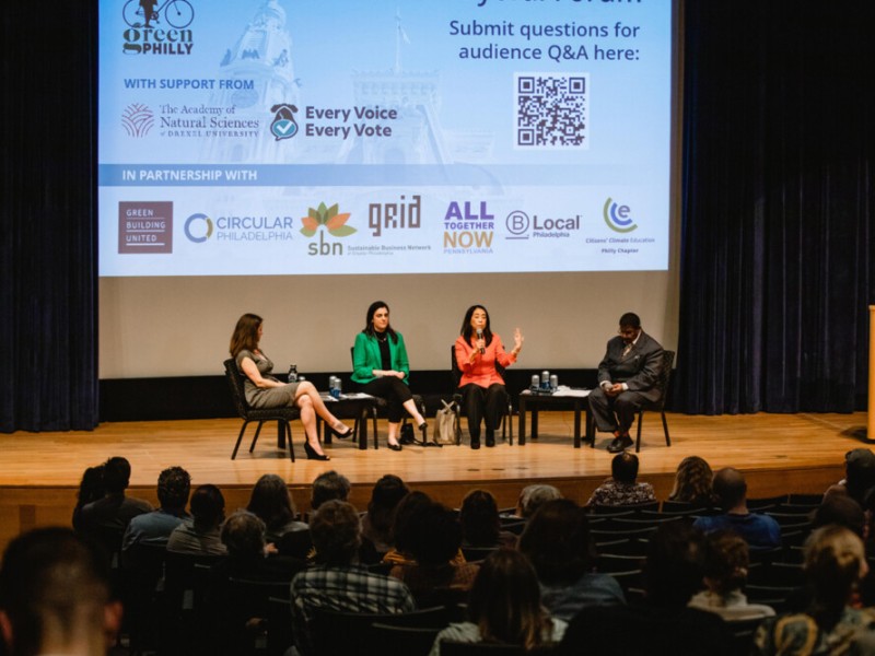 Three mayoral candidates and forum facilitator on stage for Green Philly's Climate Mayoral Forum