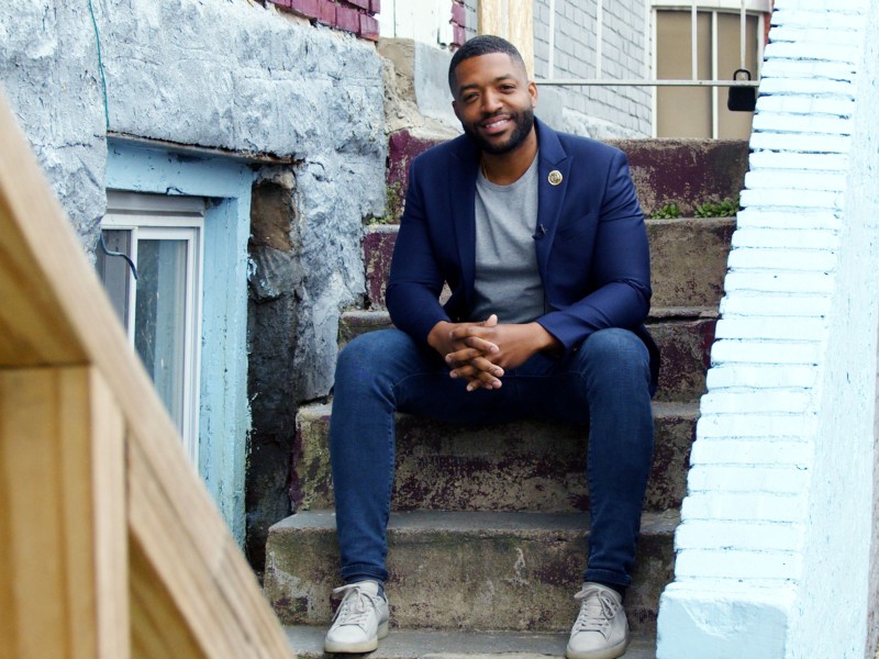 Amen Brown sitting on a front stoop