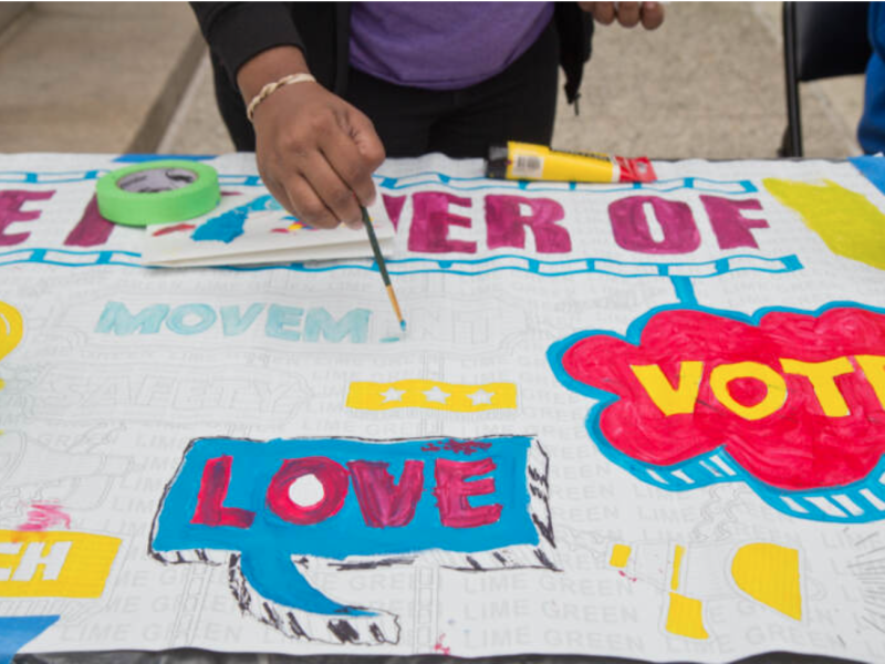 A hand panting on a community paint project 