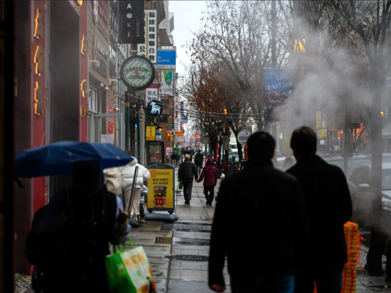 Philadelphia residents walking down a street in Chinatown 