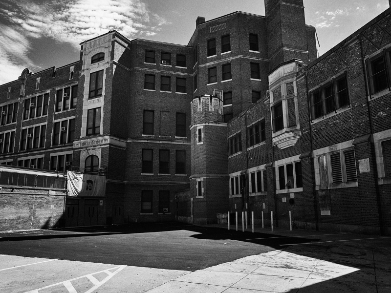 Black and white photo of a large, brick high school