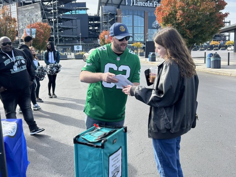 Two people talking at a mail ballot drop off event at Lincoln Financial Field
