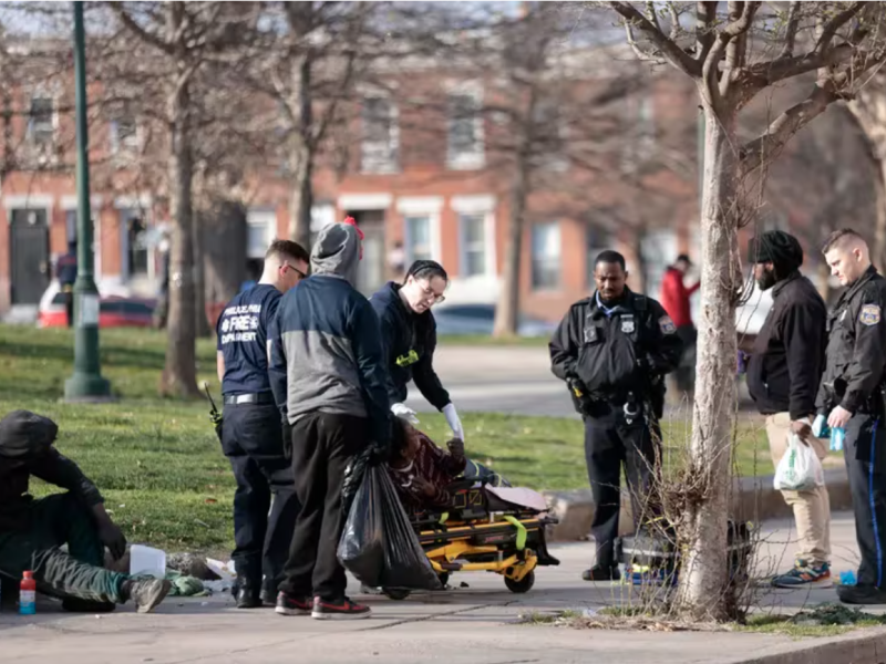 First responders adminstering Narcan to a potential overdose victim