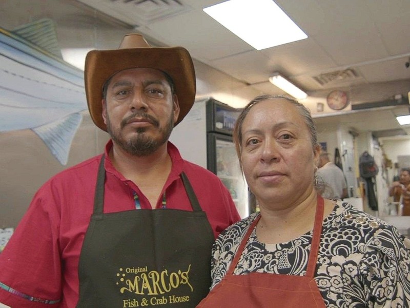 Alma and her husband, Marcos Tlacopilco, standing in their fish business