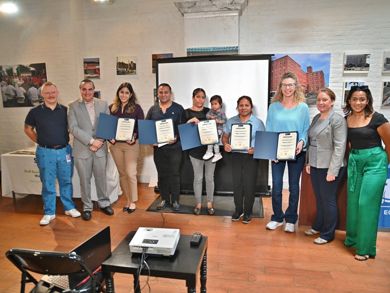 People holding certificates after completing a Department of Commerce workshop