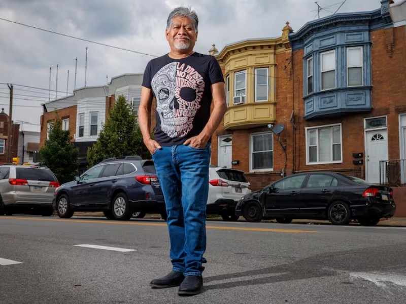 Photograph of Latino man standing in street