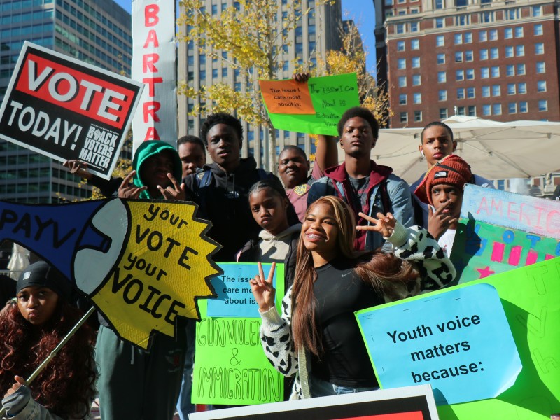 Image of students outside holding youth vote signs