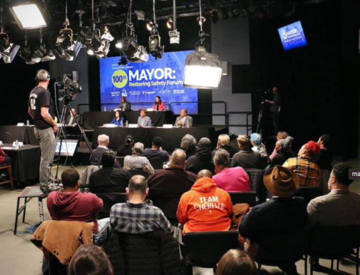 Mayoral candidates sitting on a stage in front of an audience in a TV studio