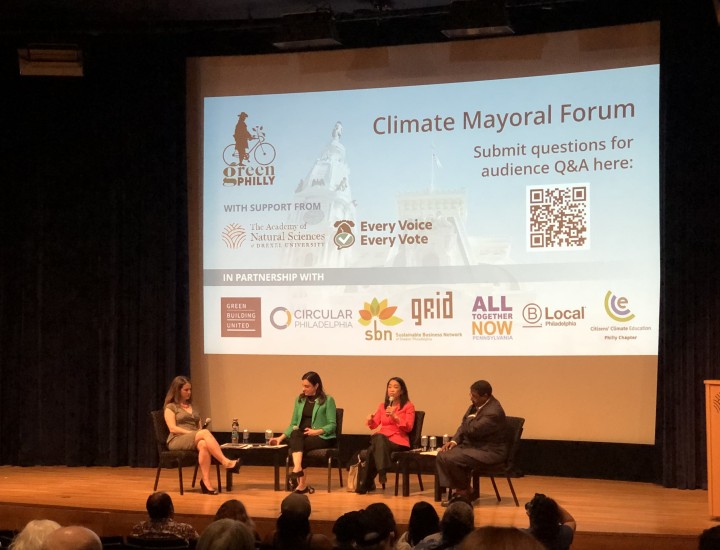 Photo of candidates and journalist on stage during Climate Mayoral Forum