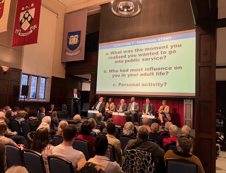 Mayoral candidates on stage in front of a large audience