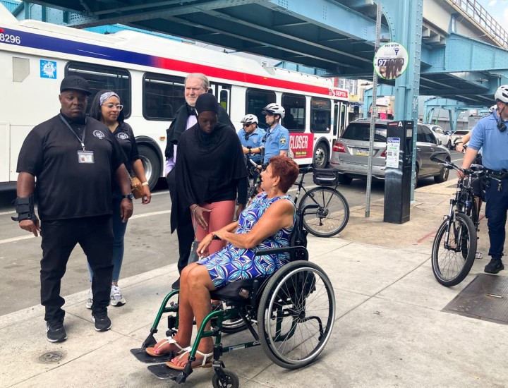 State officials talking to a resident of Kensington on a sidewalk
