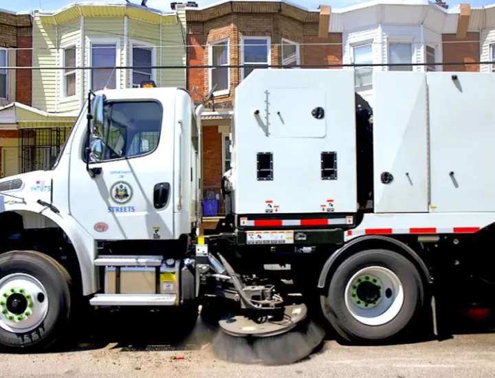 A Streets Department mechanical broom truck drives down a Philadelphia street. (BIlly Penn file photo)