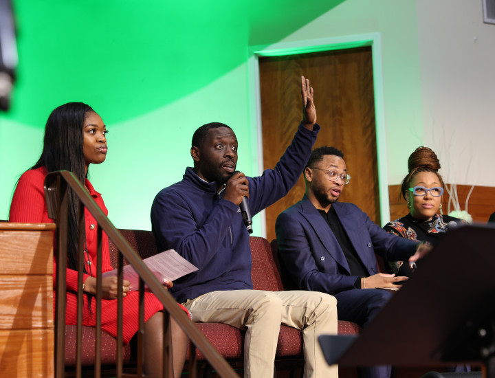 City Councilmember Isaiah Thomas raising his hand as he engages with audience at a recent panel about education funding and school closures in Philadelphia.